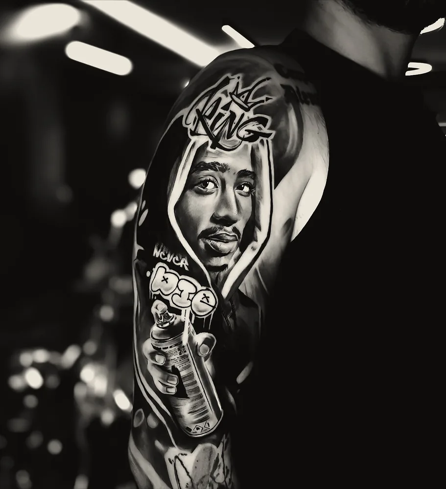 Tupac tattoo — shoulder and sleeve, black and grey realism (1)